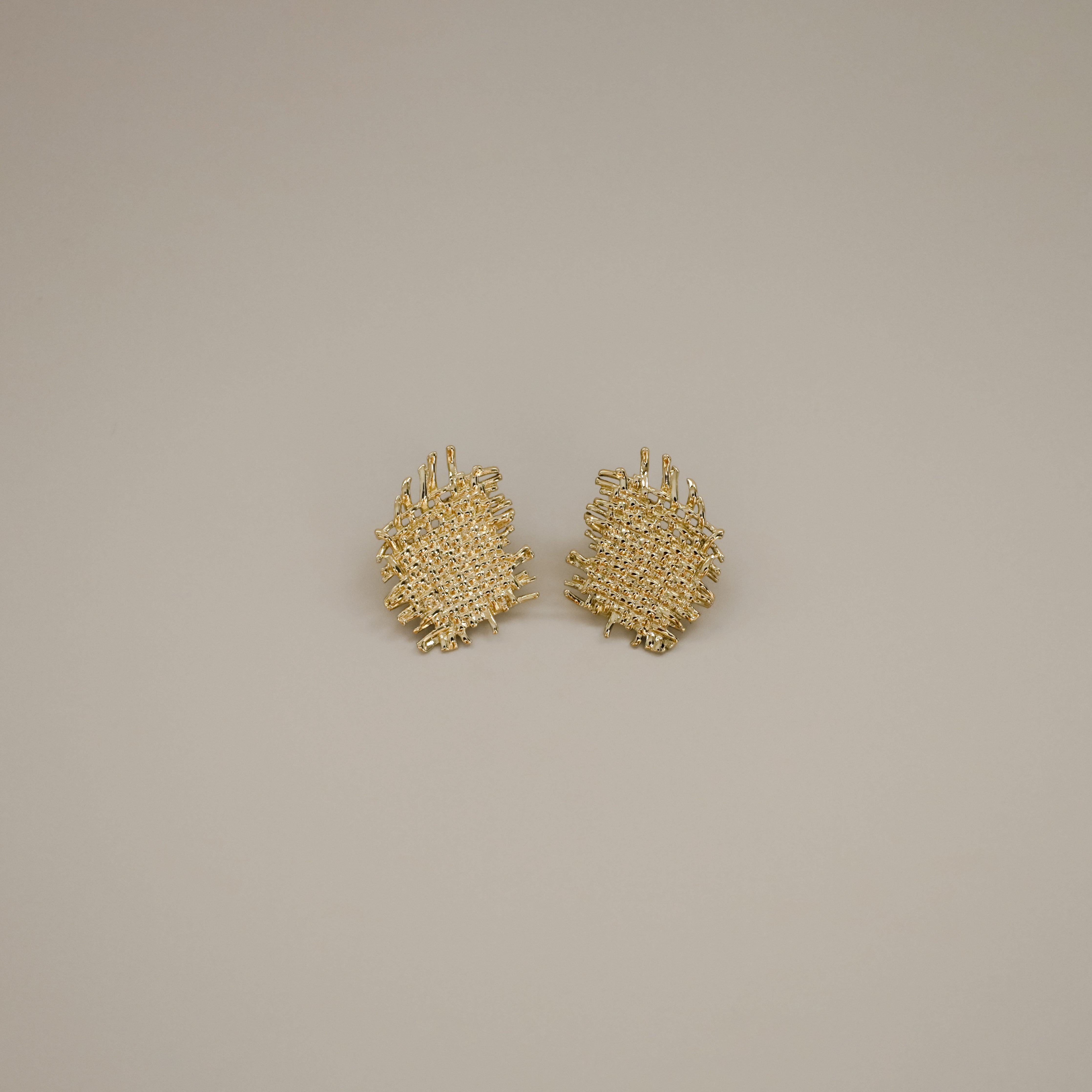eddard earrings, gold textured design that resembles woven strands