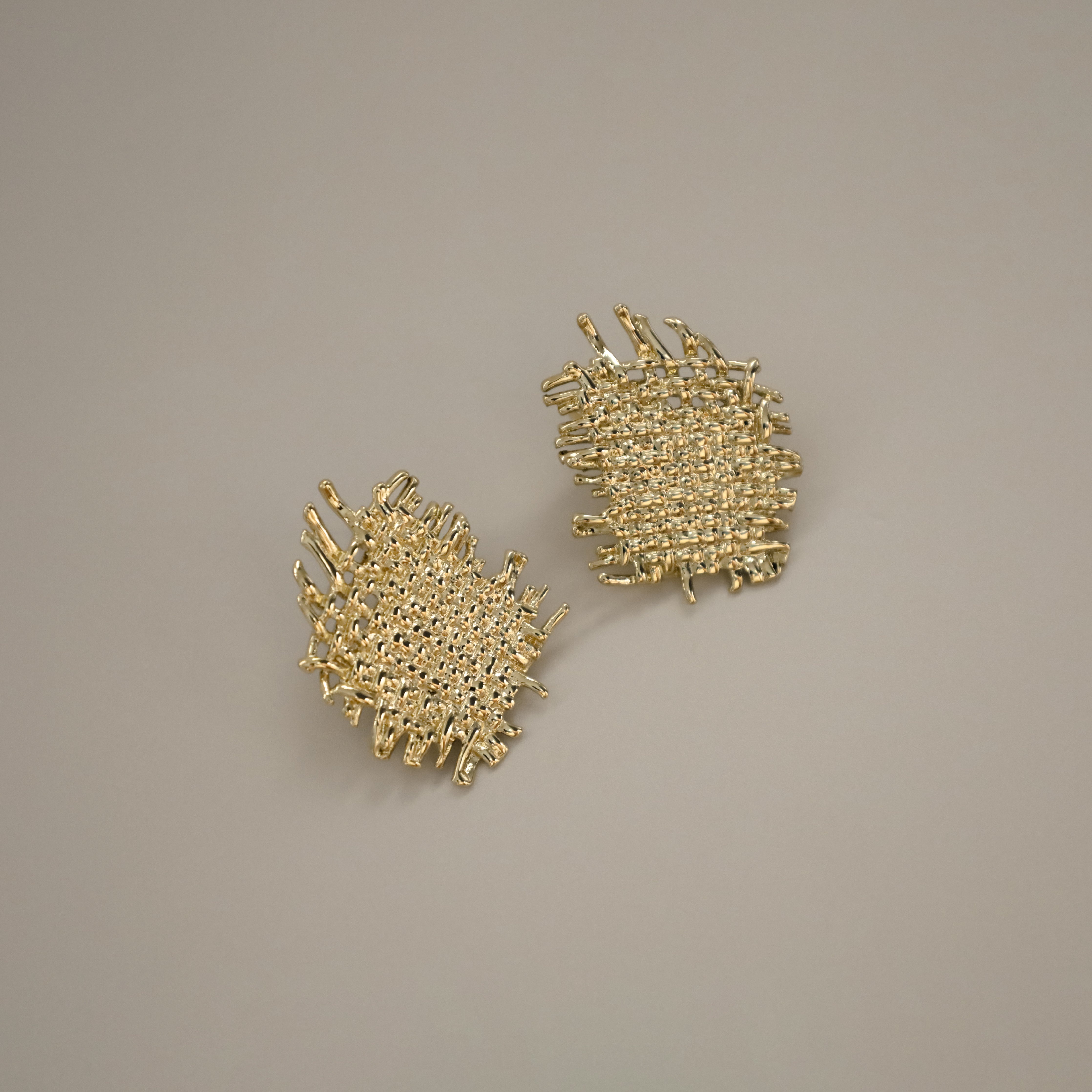 eddard earrings, gold textured design that resembles woven strands