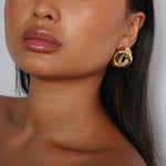 eivor earrings, gold bold, chunky statement piece with a triangular shape and a twisted looping knot-like design