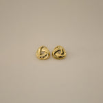 eivor earrings, gold bold, chunky statement piece with a triangular shape and a twisted looping knot-like design