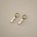 elissant earrings, two baroque freshwater pearls hanging from small gold latch back hoops
