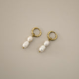 elissant earrings, two baroque freshwater pearls hanging from small gold latch back hoops