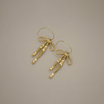 erkinne gold earrings, delicate bow design with dangling ribbons