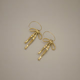 erkinne gold earrings, delicate bow design with dangling ribbons