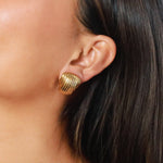 ewadi earrings, gold, distinctive staggered, layered design with a ribbed texture that wraps around in a curved, dome-like shape