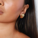 ewadi earrings, gold, distinctive staggered, layered design with a ribbed texture that wraps around in a curved, dome-like shape