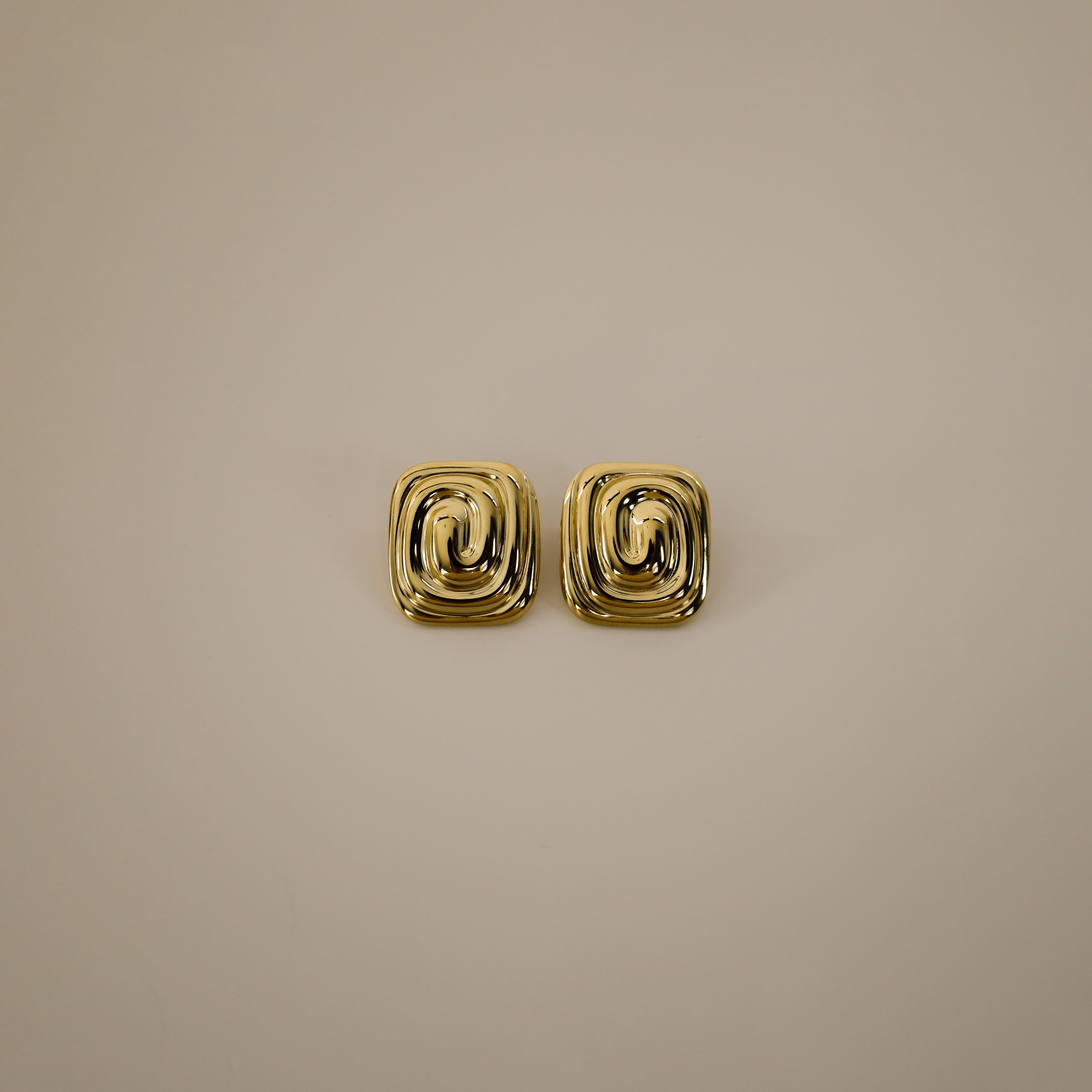 ederne earrings, gold bold square design with a unique, layered spiral pattern