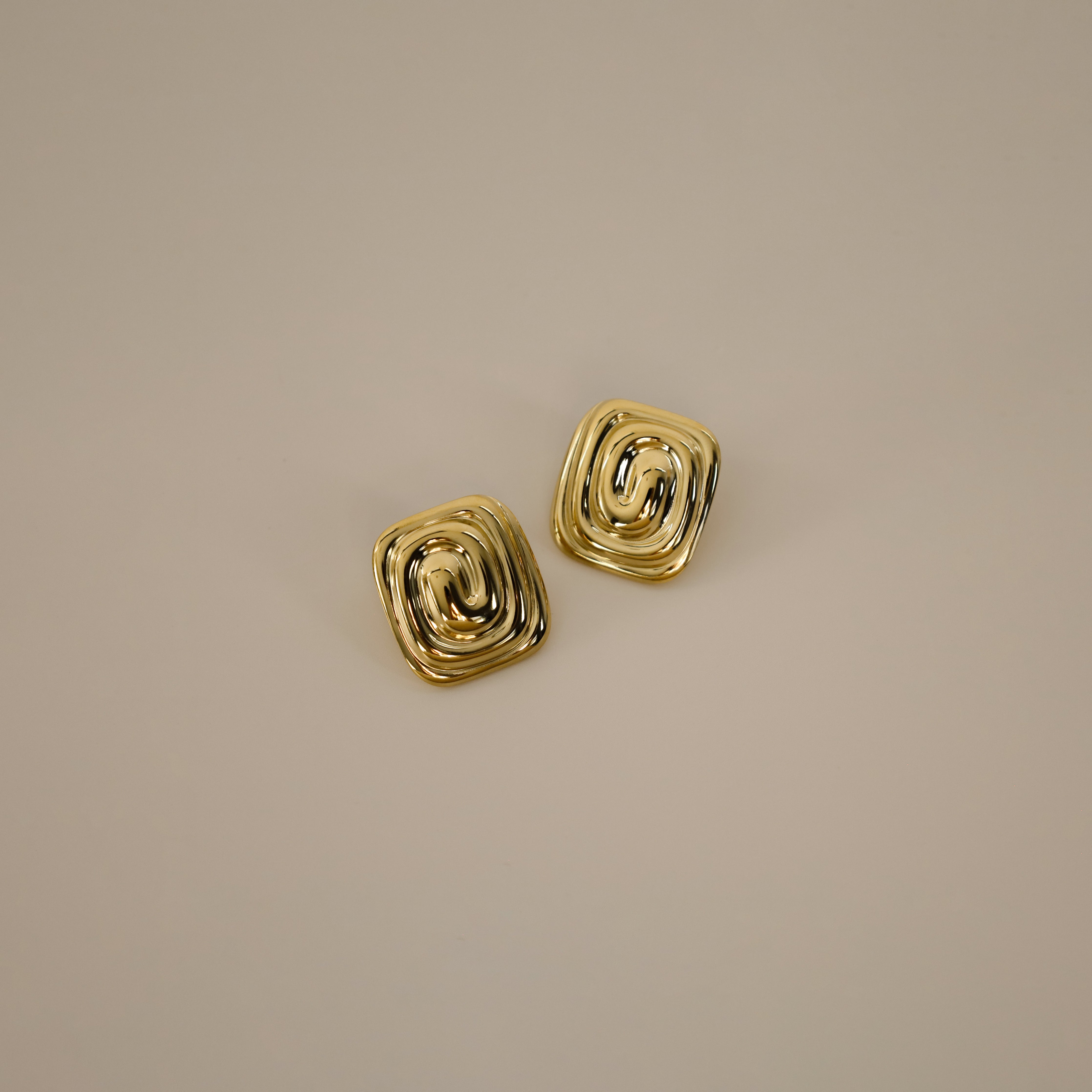 ederne earrings, gold bold square design with a unique, layered spiral pattern