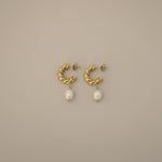 eharli earrings, twisted gold hoop design accented by a single dangling freshwater pearl