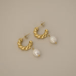 eharli earrings, twisted gold hoop design accented by a single dangling freshwater pearl