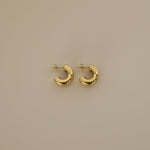 elidi earrings, gold bold double hoop earrings adorned with delicate, sparkling Cubic Zirconia stones sprinkled throughout