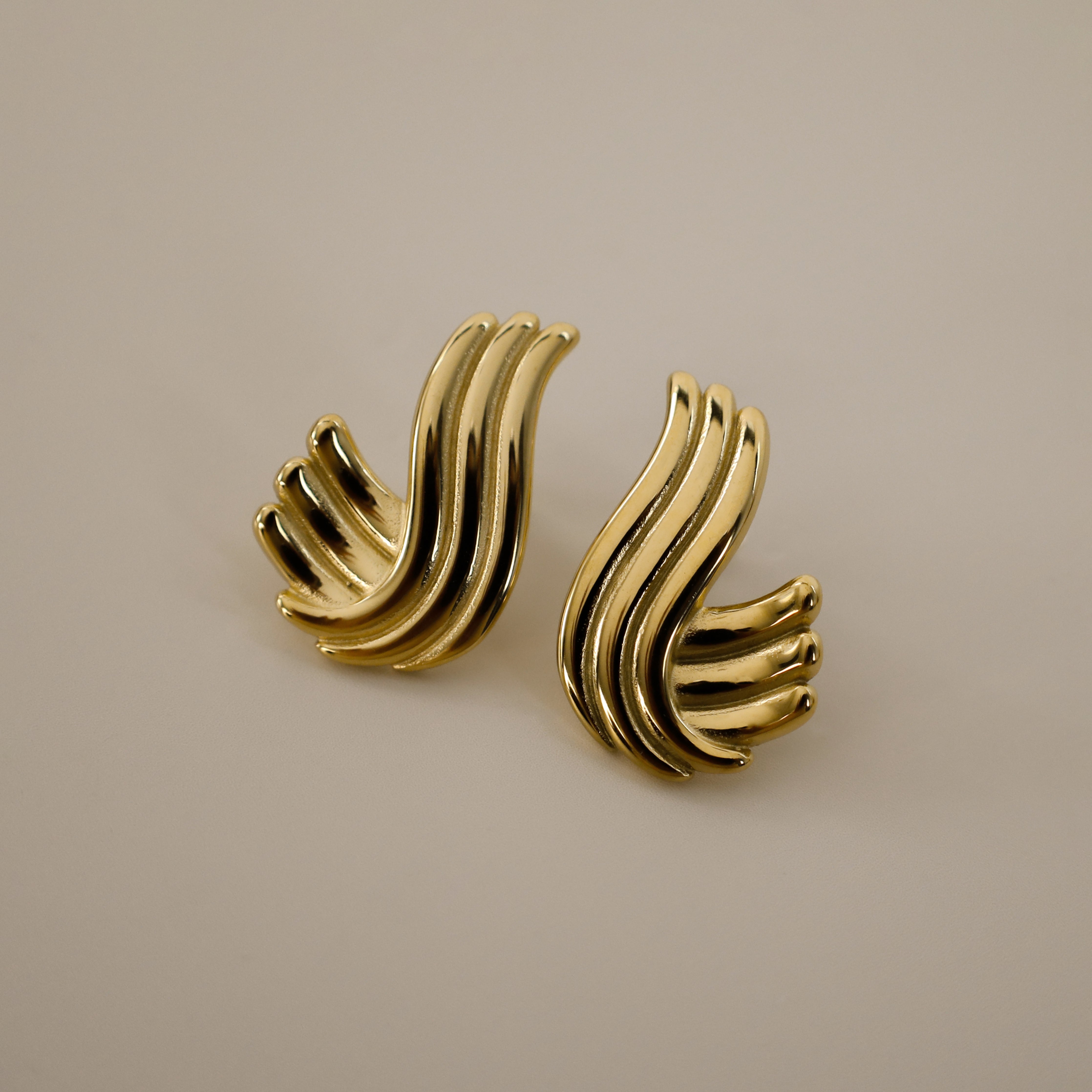 estri earrings, vintage inspired, gold, ribbed, fluid, wave-like form that wraps gently around the earlobes