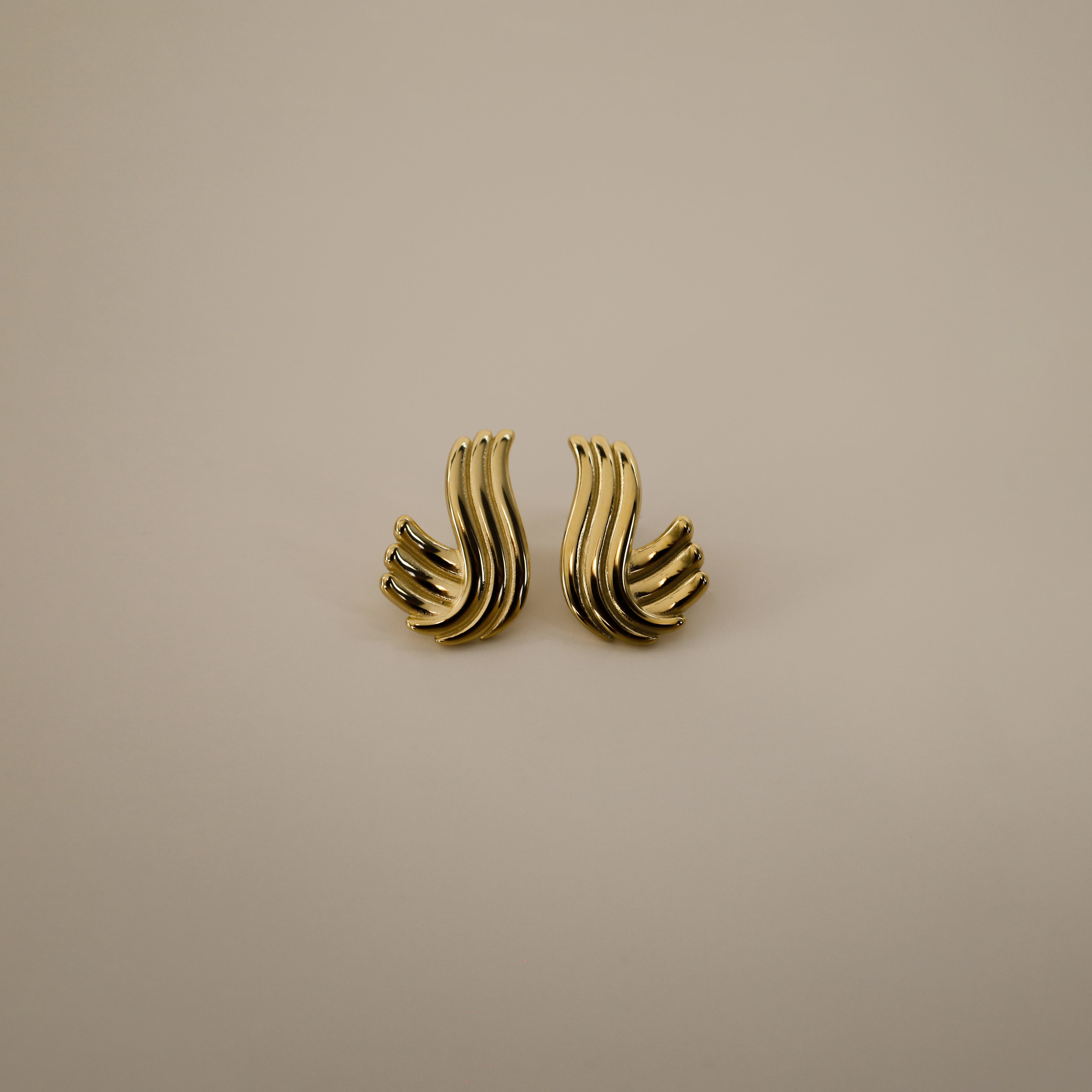 estri earrings, vintage inspired, gold, ribbed, fluid, wave-like form that wraps gently around the earlobes