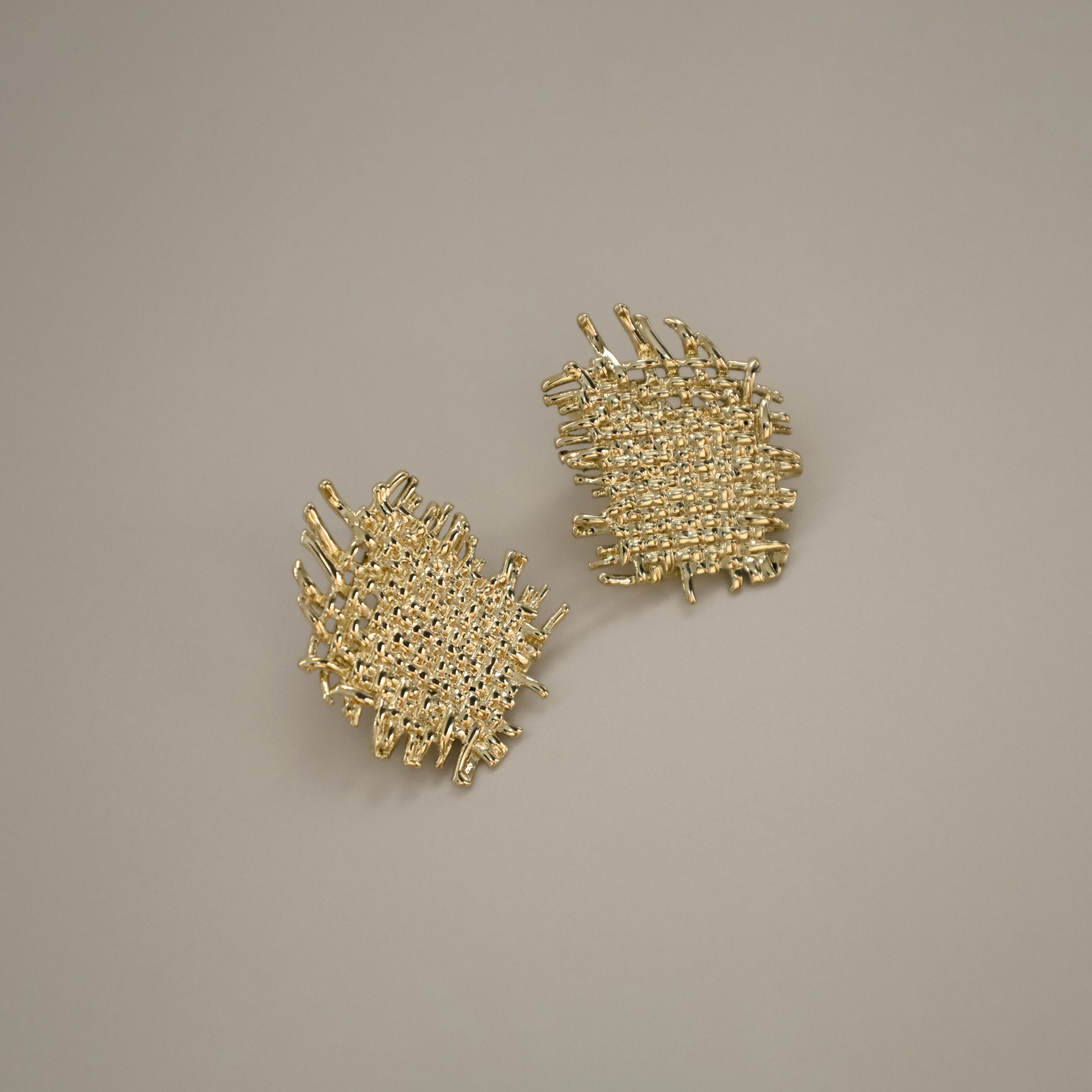 eddard earrings, gold textured design that resembles woven strands