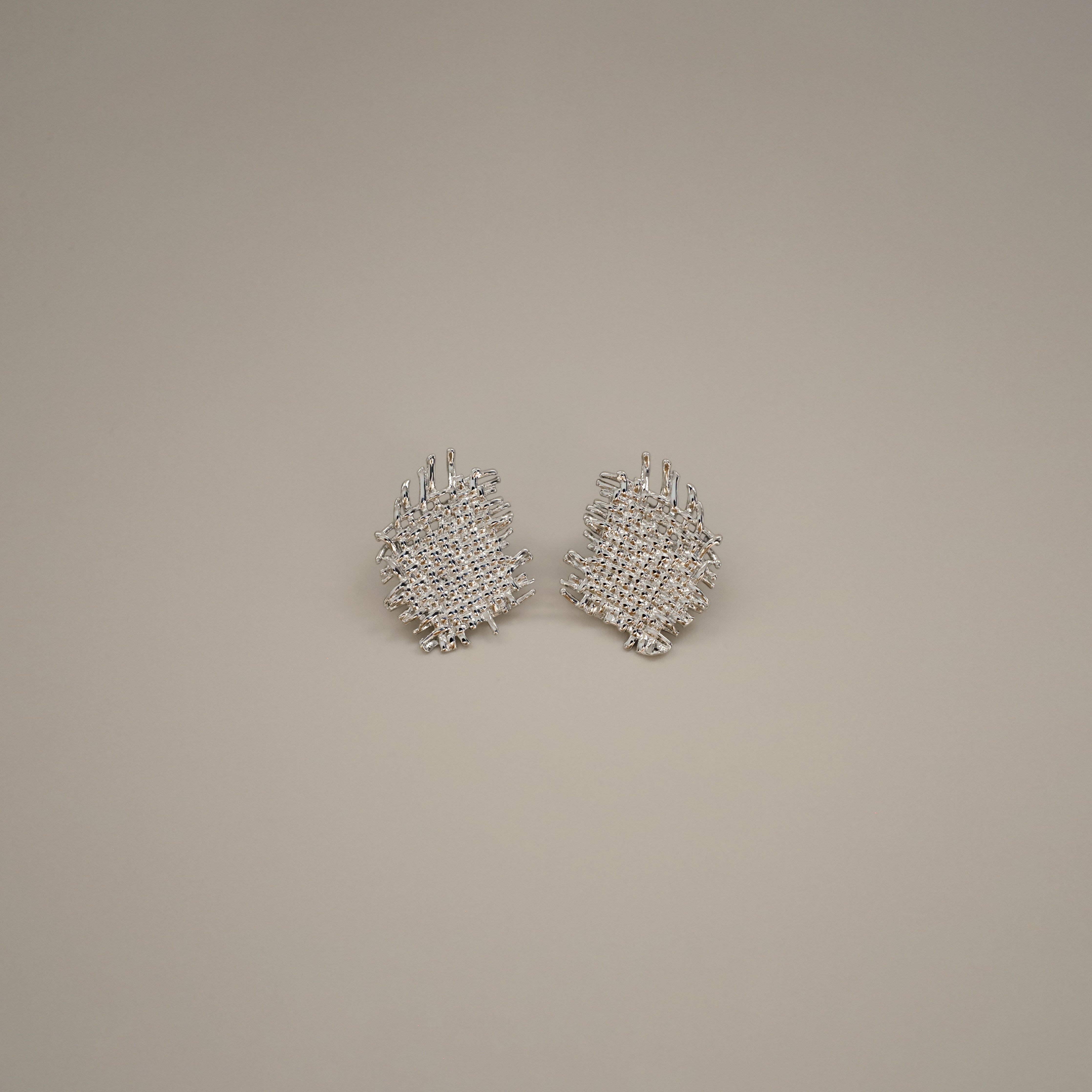 eddard earrings, silver textured design that resembles woven strands