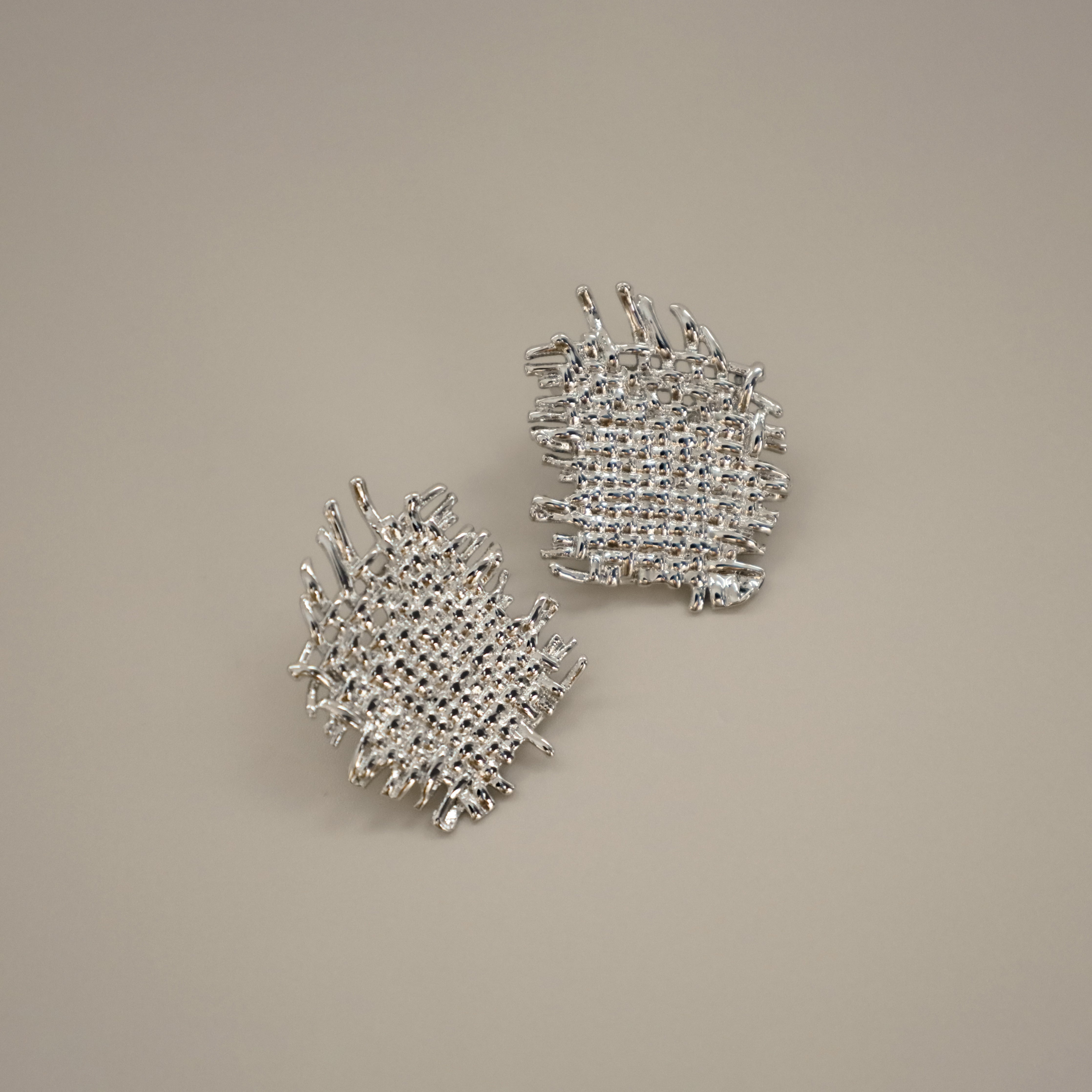 eddard earrings, silver textured design that resembles woven strands