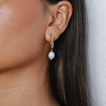 eharli earrings, twisted gold hoop design accented by a single dangling freshwater pearl