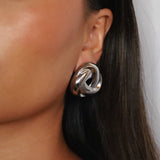 eivor earrings, silver bold, chunky statement piece with a triangular shape and a twisted looping knot-like design