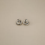 eivor earrings, silver bold, chunky statement piece with a triangular shape and a twisted looping knot-like design