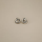 eivor earrings, silver bold, chunky statement piece with a triangular shape and a twisted looping knot-like design