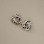 eivor earrings, silver bold, chunky statement piece with a triangular shape and a twisted looping knot-like design