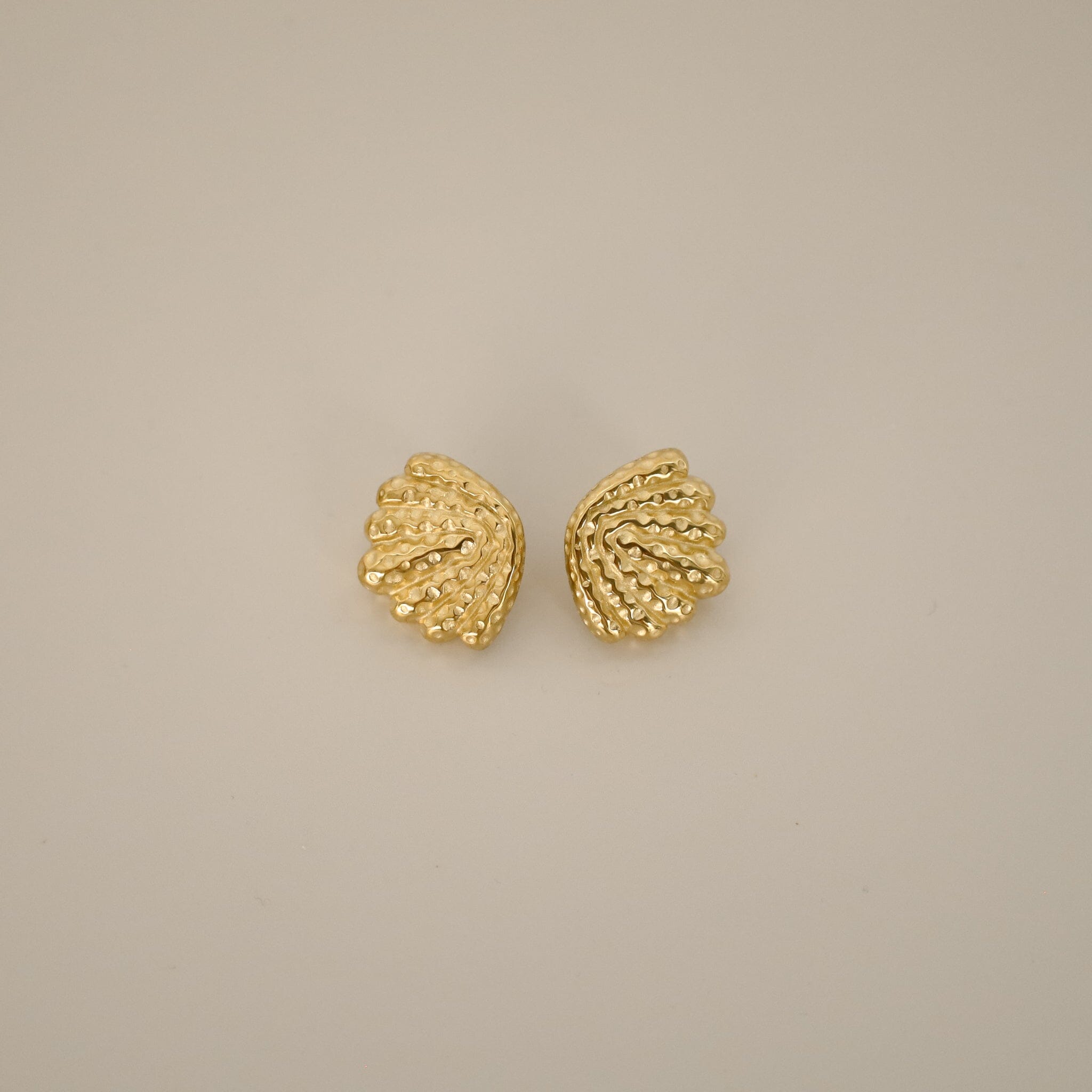 elestri earrings, gold earrings, shell-like shape with a hammered texture