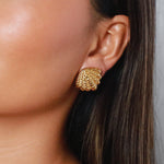 elestri earrings, gold earrings, shell-like shape with a hammered texture