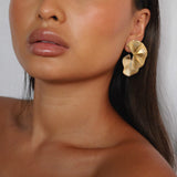 elili earrings, gold bold statement earrings with a wavy double fan-like shape and detailed with fine ribbed lines