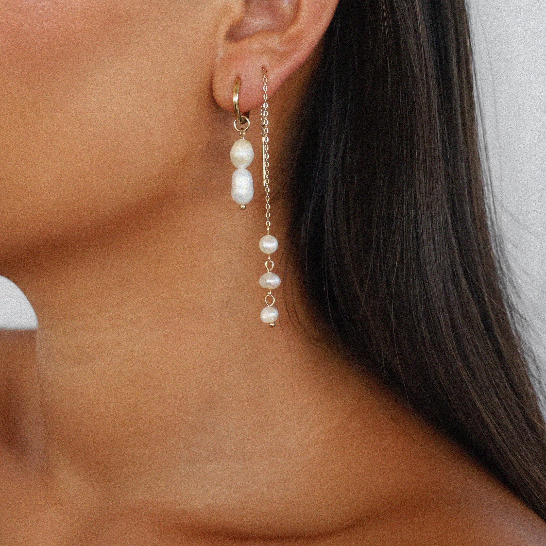 elissant earrings, two baroque freshwater pearls hanging from small gold latch back hoops