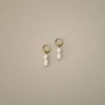 elissant earrings, two baroque freshwater pearls hanging from small gold latch back hoops