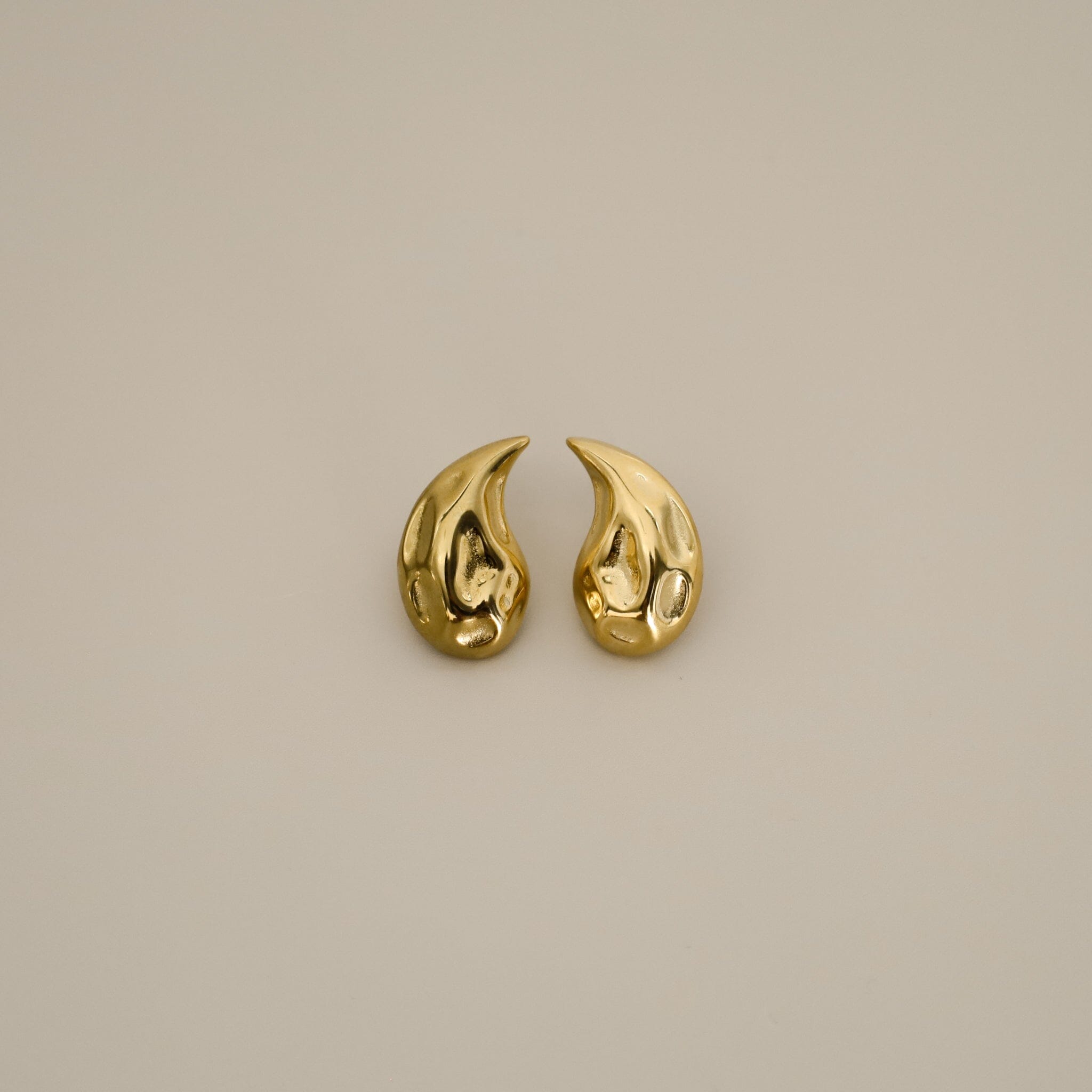 elwood gold earrings, small stud earrings featuring a curved teardrop shape with an irregular texture