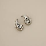 elwood silver earrings, small stud earrings featuring a curved teardrop shape with an irregular texture