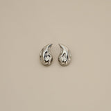 elwood silver earrings, small stud earrings featuring a curved teardrop shape with an irregular texture