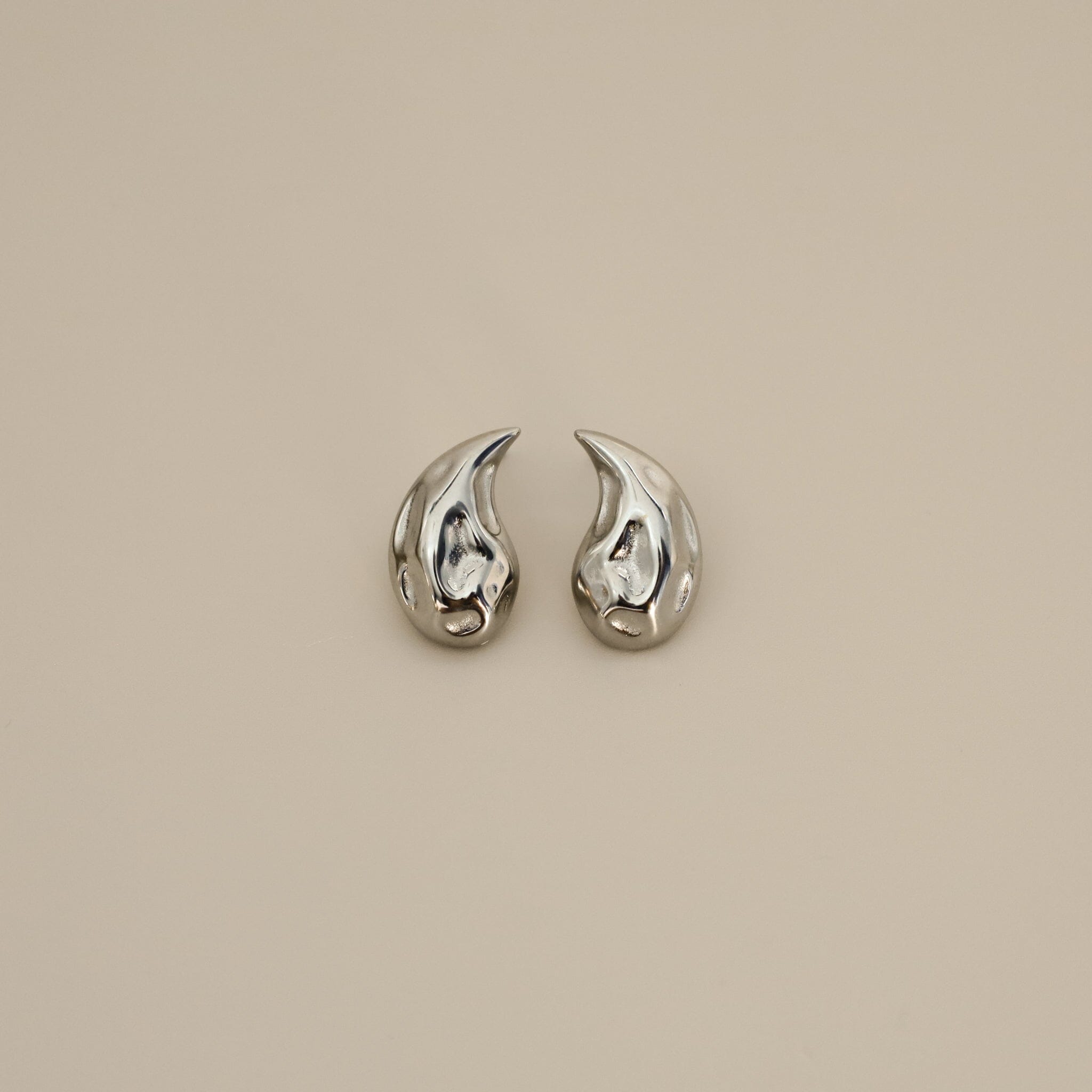 elwood silver earrings, small stud earrings featuring a curved teardrop shape with an irregular texture