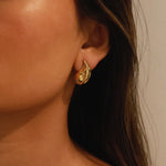 elwood gold earrings, small stud earrings featuring a curved teardrop shape with an irregular texture