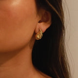 elwood gold earrings, small stud earrings featuring a curved teardrop shape with an irregular texture