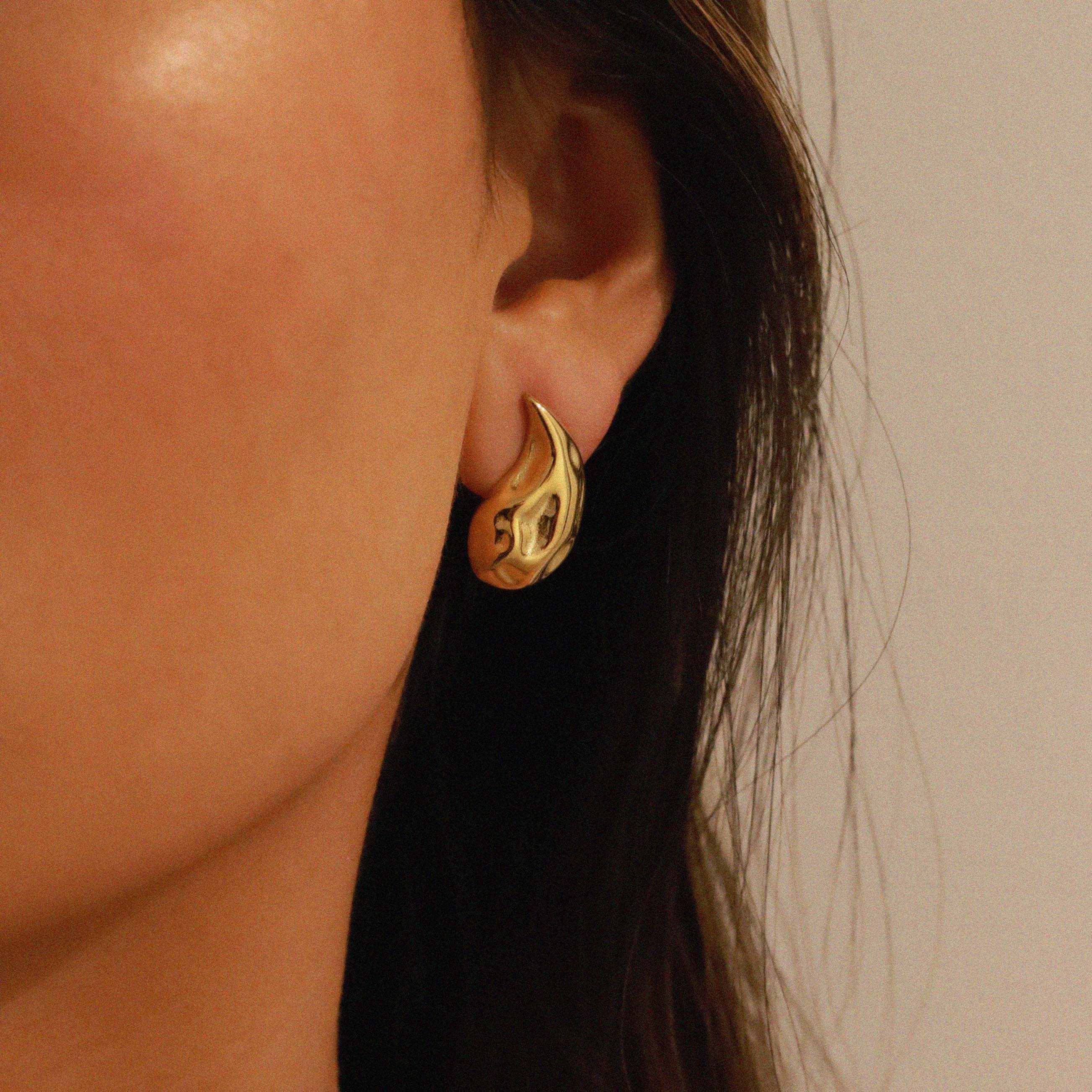 elwood gold earrings, small stud earrings featuring a curved teardrop shape with an irregular texture