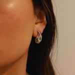 elwood silver earrings, small stud earrings featuring a curved teardrop shape with an irregular texture