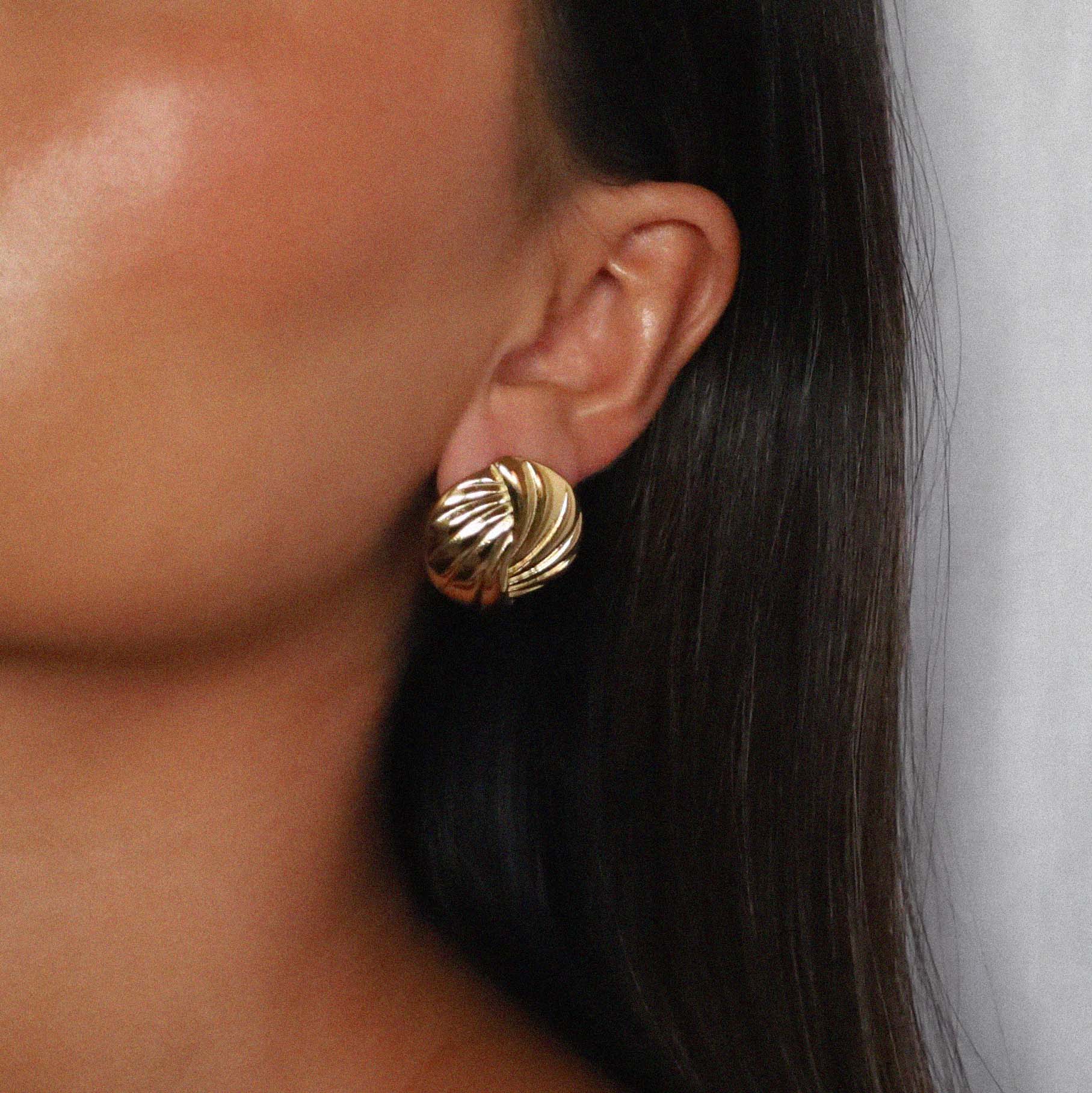 eppera earrings, gold circular design with a beautifully ribbed pattern that swirls around the surface