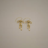 erkinne gold earrings, delicate bow design with dangling ribbons