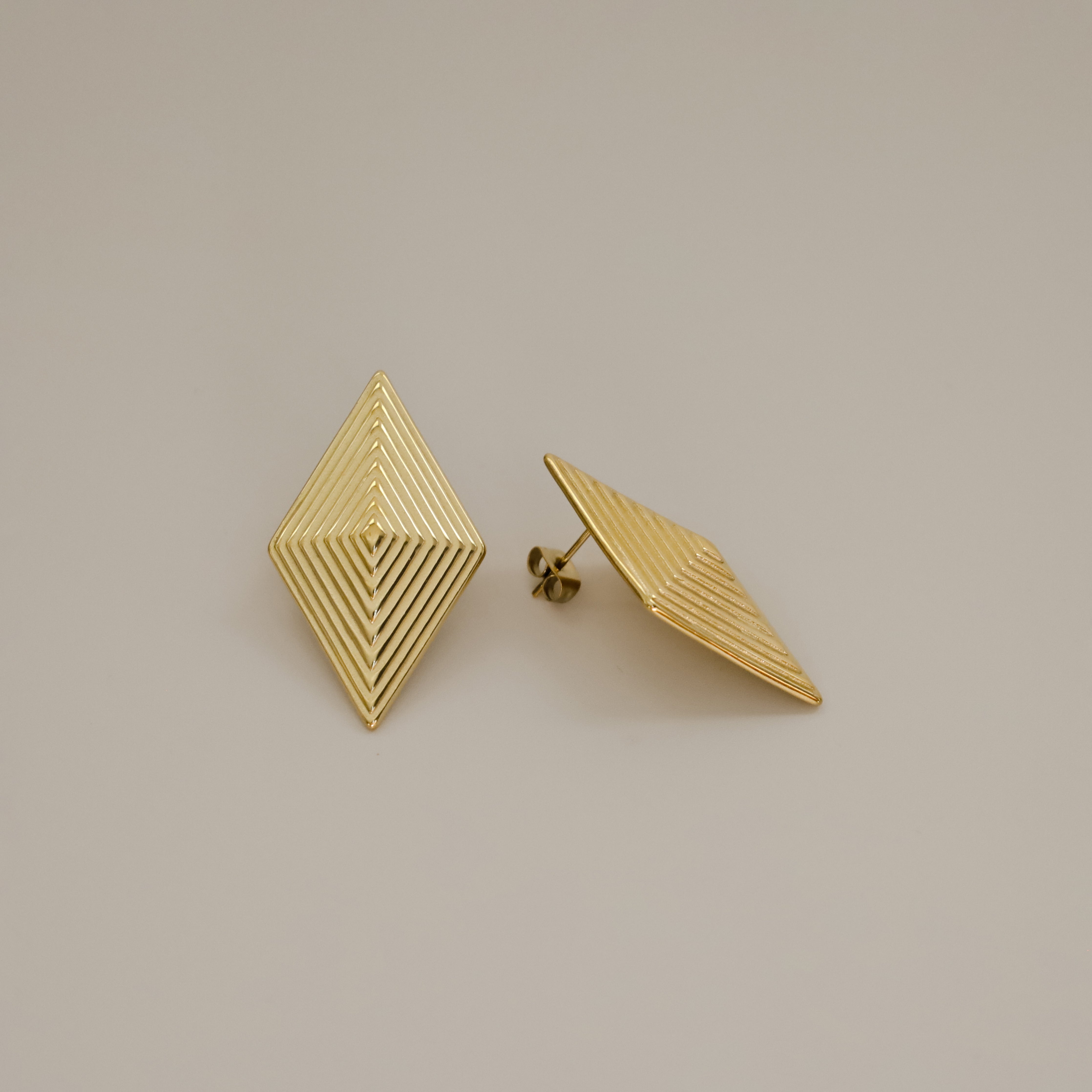 erlea earrings, gold bold diamond shape with a layered, ridged design