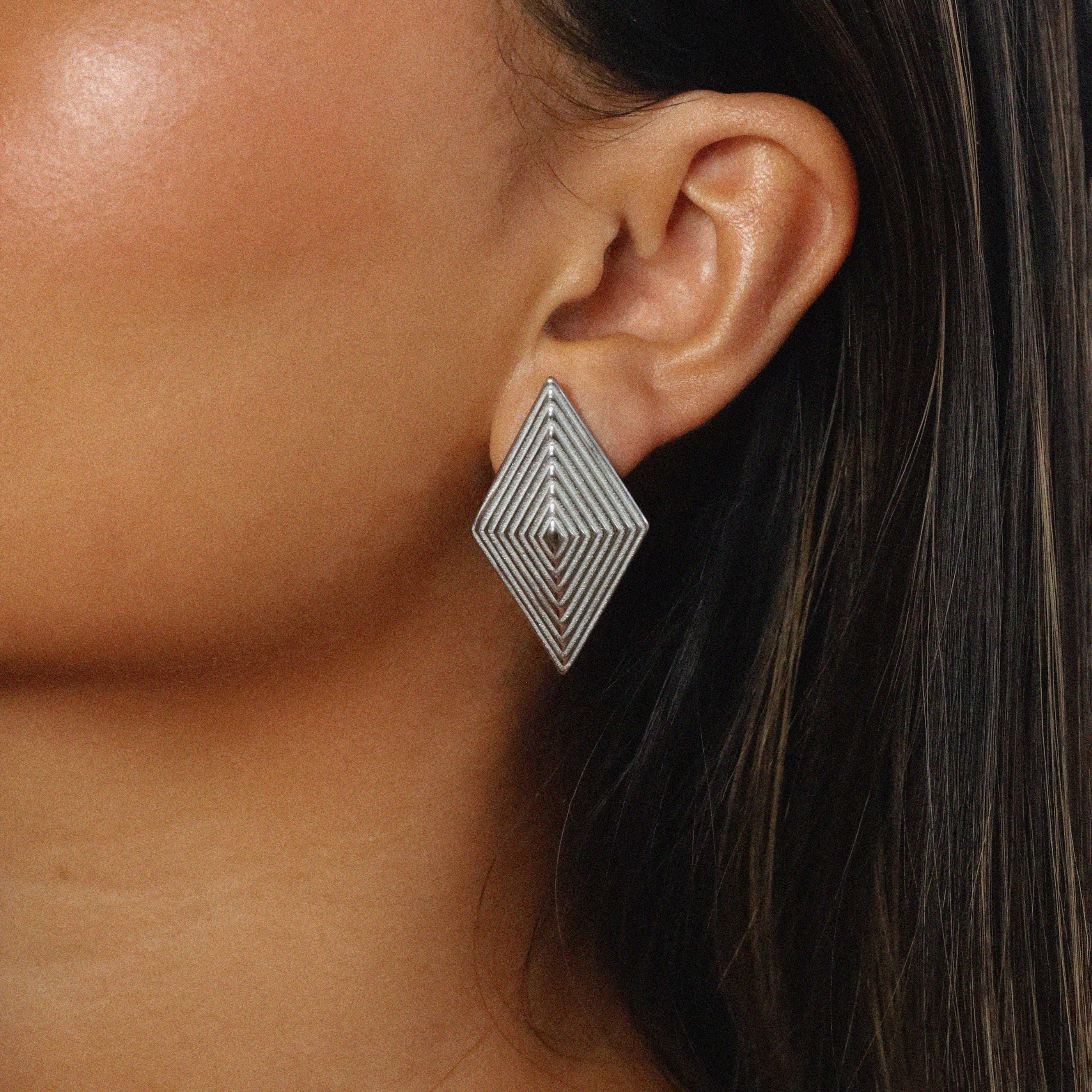 erlea earrings, silver bold diamond shape with a layered, ridged design