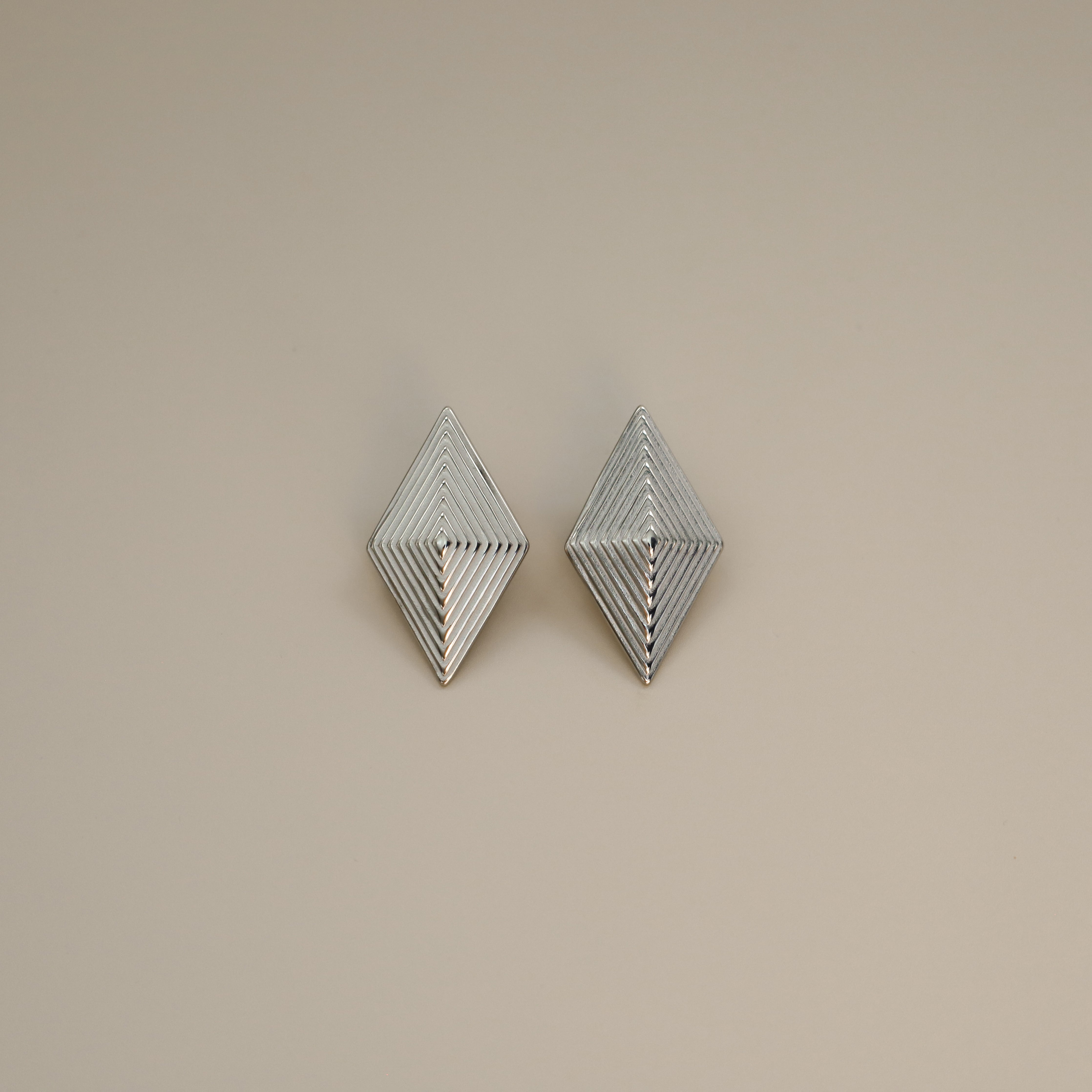 erlea earrings, silver bold diamond shape with a layered, ridged design