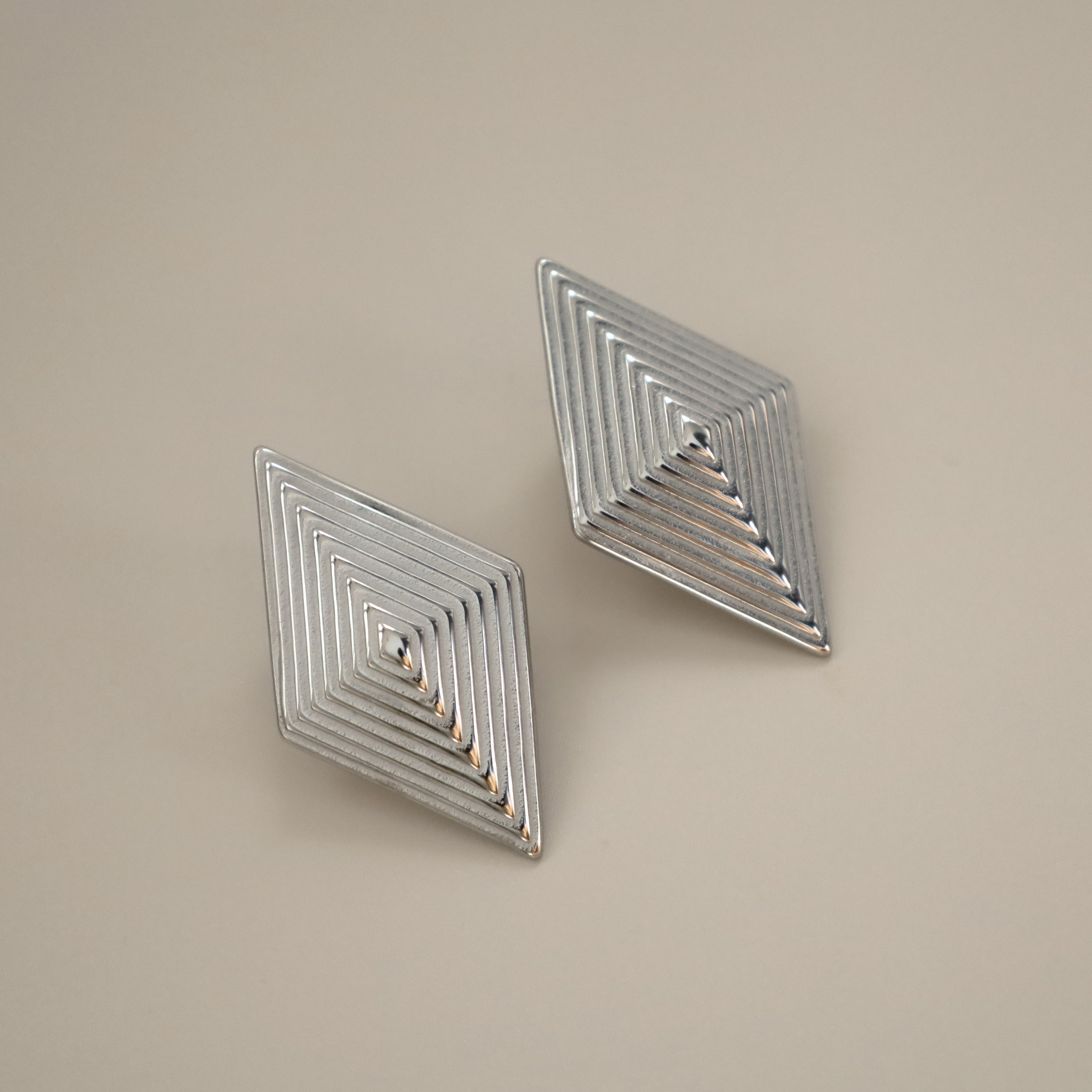 erlea earrings, silver bold diamond shape with a layered, ridged design