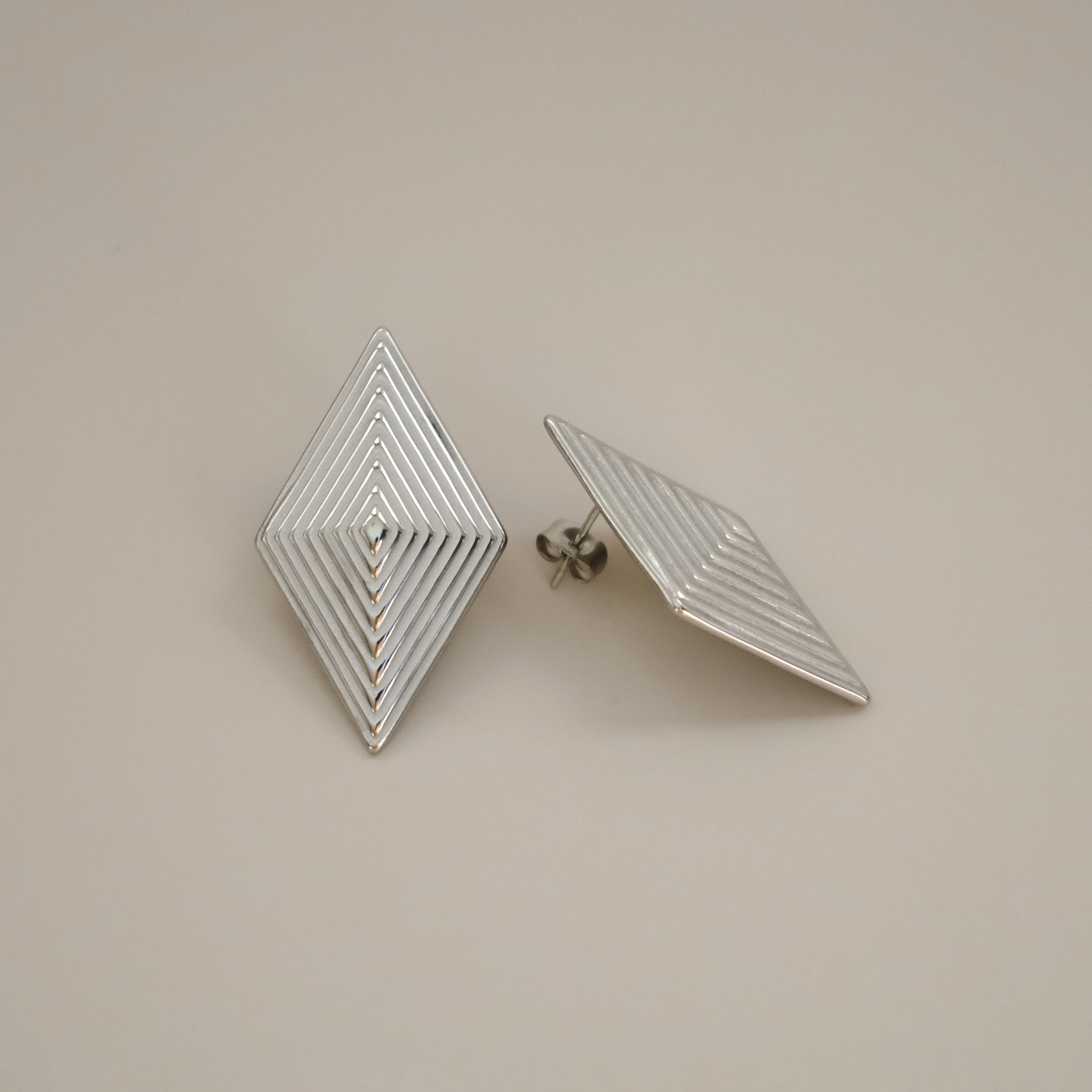 erlea earrings, silver bold diamond shape with a layered, ridged design