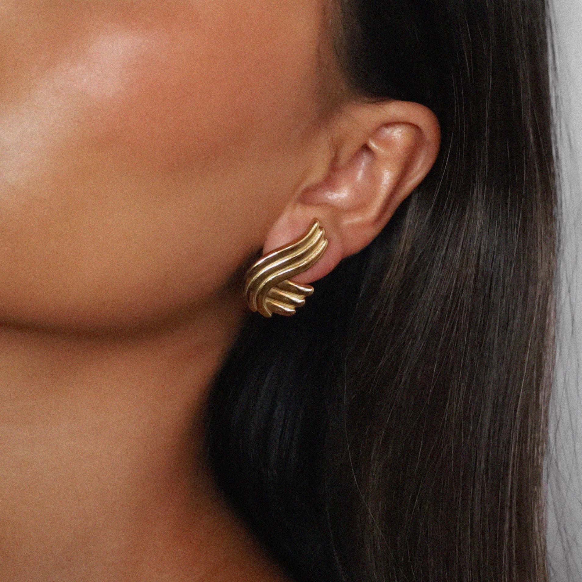 estri earrings, vintage inspired, gold, ribbed, fluid, wave-like form that wraps gently around the earlobes