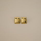 evrim earrings, gold bold rectangle design with a smooth domed surface