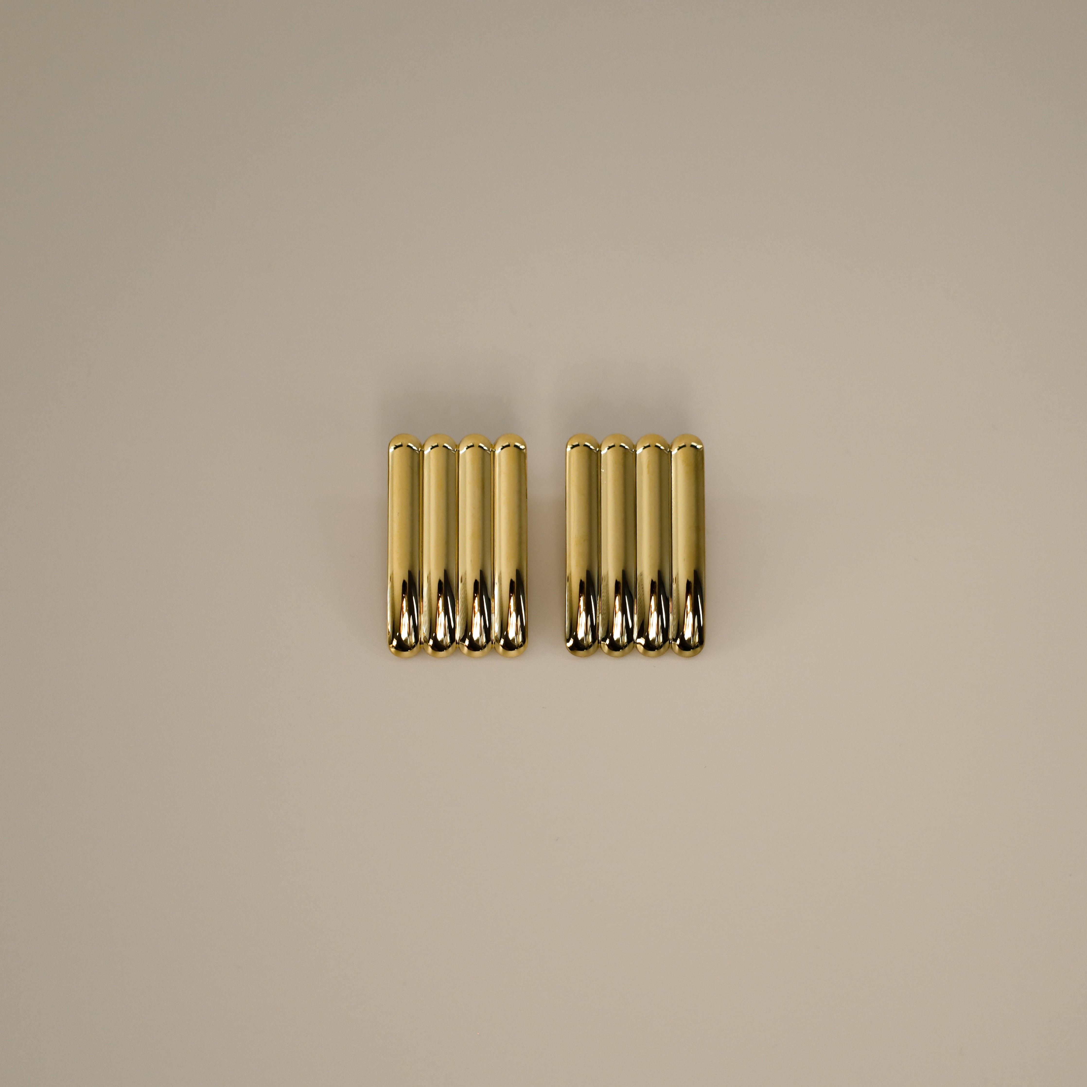 ewella earrings, gold rectangular-shaped statement earrings that feature a thick vertical ribbed design