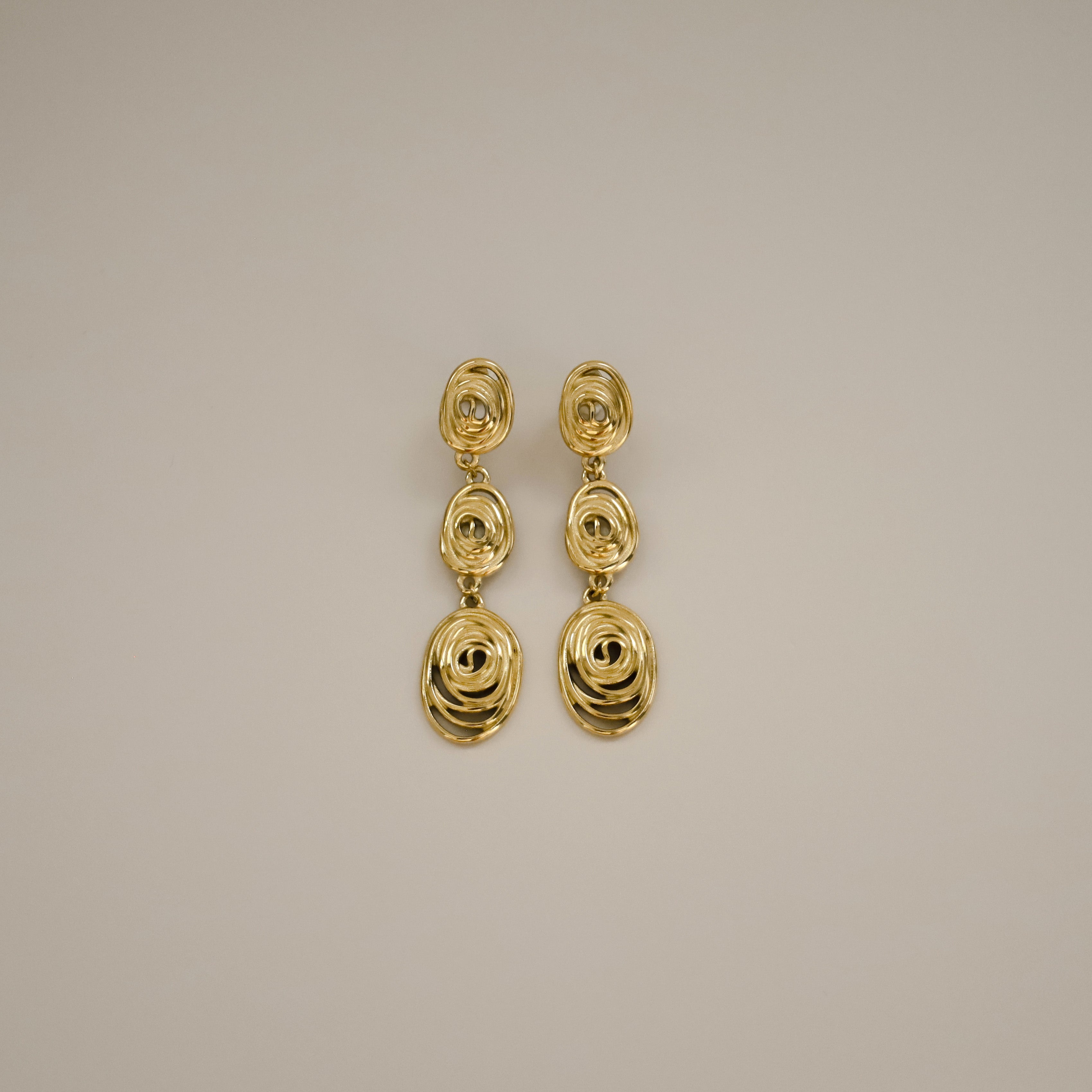 gold eydis earrings, three delicate layered spirals creating a cascading effect